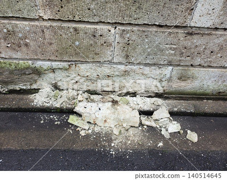 A block wall made of Oya stone that has deteriorated over time, crumbling and falling apart. A block wall made of Oya stone that has deteriorated over time, crumbling and falling apart. 140514645
