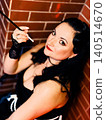 Stylish woman holding cigarette holder portraying retro glamour 140514670