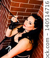 Woman embodying 1920s vintage style with cigarette holder 140514716