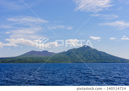A spectacular view of Lake Shikotsu (blue) and Mount Fuppushi and Mount Tarumae in Chitose City, Hokkaido. A spectacular view of Lake Shikotsu (blue) and Mount Fuppushi and Mount Tarumae in Chitose City, Hokkaido. 140514724