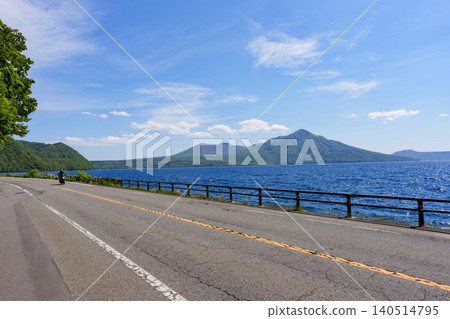 A scenic drive through Hokkaido offering stunning views of Lake Shikotsu, Mount Tarumae, and Mount Fuppushi. A scenic drive through Hokkaido offering stunning views of Lake Shikotsu, Mount Tarumae, and Mount Fuppushi. 140514795