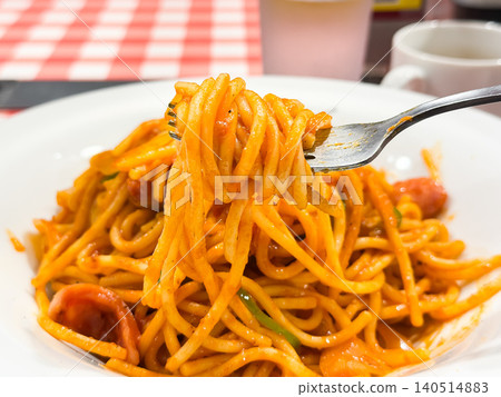 Japanese-style Neapolitan spaghetti. Western-style spaghetti seasoned with tomato ketchup sauce. Noodles lifted with a fork. Japanese-style Neapolitan spaghetti. Western-style spaghetti seasoned with tomato ketchup sauce. Noodles lifted with a fork. 140514883