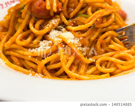 Japanese-style Neapolitan spaghetti. Western-style spaghetti seasoned with tomato ketchup sauce. Close-up of grated cheese. Japanese-style Neapolitan spaghetti. Western-style spaghetti seasoned with tomato ketchup sauce. Close-up of grated cheese. 140514885