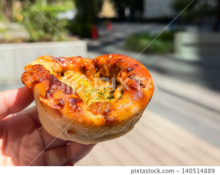 Freshly baked curry bread, held by hand. Soft bread made to encase the curry sauce. Freshly baked curry bread, held by hand. Soft bread made to encase the curry sauce. 140514889