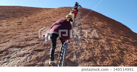 [Before climbing was prohibited] Scenes of climbing Ayers Rock, Australia, on its steep slopes, relying on chains to ascend. 140514991