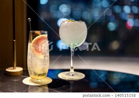 Stylish cocktails with a night view as a backdrop Stylish cocktails with a night view as a backdrop 140515158