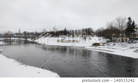 Winter cityscape with a river and orthodox cathedrals under a cloudy sky. Winter cityscape with a river and orthodox cathedrals under a cloudy sky. 140515242