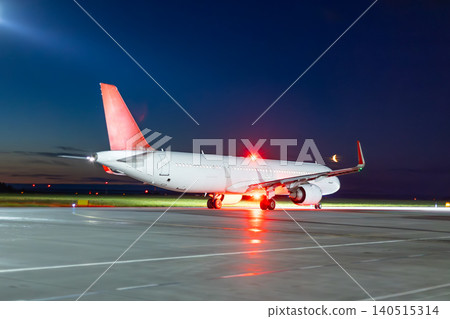 Modern passenger airliner taxiing at the night airport Modern passenger airliner taxiing at the night airport 140515314