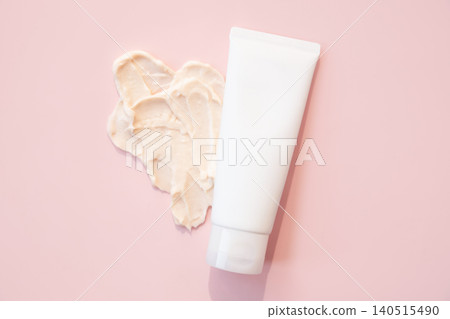 White tube with cosmetic cream and smear on pink background. Skincare product for face or body care routine. Beauty treatment, spa and dermatological supply for moisturizing procedure. White tube with cosmetic cream and smear on pink background. Skincare product for face or body care routine. Beauty treatment, spa and dermatological supply for moisturizing procedure. 140515490