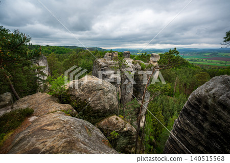 Rock city formations in Hruboskalsko, Bohemian Paradise (Cesky raj), Czech Republic, with peaks of giant sandstone rocks and cliffs emerging from light morning mist panoramic view Rock city formations in Hruboskalsko, Bohemian Paradise (Cesky raj), Czech Republic, with peaks of giant sandstone rocks and cliffs emerging from light morning mist panoramic view 140515568