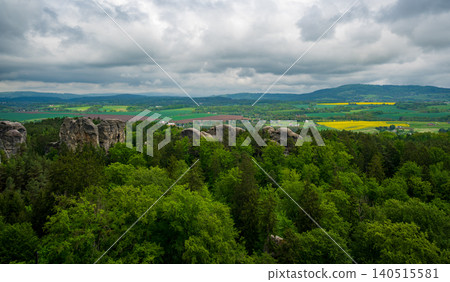 View from the tower of Hruba Skala Castle over the landscape of Bohemian Paradise (Cesky raj), Czech Republic, with silhouette of Trosky Castle ruin in the distance under dramatic soft sky panorama View from the tower of Hruba Skala Castle over the landscape of Bohemian Paradise (Cesky raj), Czech Republic, with silhouette of Trosky Castle ruin in the distance under dramatic soft sky panorama 140515581