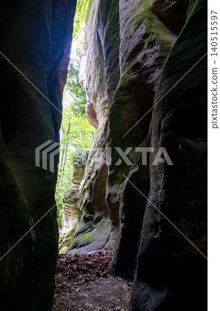 Massive sandstone rock formations along a forest trail in Bohemian Paradise (Cesky raj), Hruba Skala area (Hruboskalsko), Czech Republic, with giant stones rising above woodland path Massive sandstone rock formations along a forest trail in Bohemian Paradise (Cesky raj), Hruba Skala area (Hruboskalsko), Czech Republic, with giant stones rising above woodland path 140515597