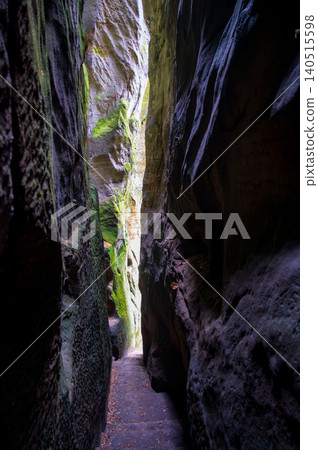 Massive sandstone rock formations along a forest trail in Bohemian Paradise (Cesky raj), Hruba Skala area (Hruboskalsko), Czech Republic, with giant stones rising above woodland path Massive sandstone rock formations along a forest trail in Bohemian Paradise (Cesky raj), Hruba Skala area (Hruboskalsko), Czech Republic, with giant stones rising above woodland path 140515598