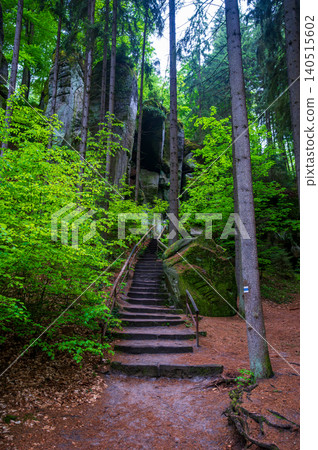 Massive sandstone rock formations along a forest trail in Bohemian Paradise (Cesky raj), Hruba Skala area (Hruboskalsko), Czech Republic, with giant stones rising above woodland path Massive sandstone rock formations along a forest trail in Bohemian Paradise (Cesky raj), Hruba Skala area (Hruboskalsko), Czech Republic, with giant stones rising above woodland path 140515602