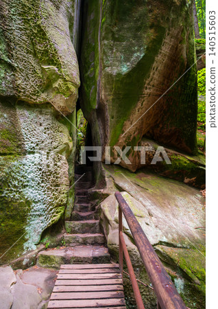 Massive sandstone rock formations along a forest trail in Bohemian Paradise (Cesky raj), Hruba Skala area (Hruboskalsko), Czech Republic, with giant stones rising above woodland path Massive sandstone rock formations along a forest trail in Bohemian Paradise (Cesky raj), Hruba Skala area (Hruboskalsko), Czech Republic, with giant stones rising above woodland path 140515603