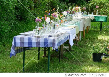 Rustic floral wedding table in the countryside in summer Rustic floral wedding table in the countryside in summer 140515960