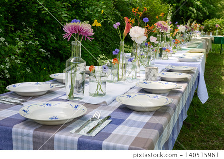 Rustic floral wedding table in the countryside in summer Rustic floral wedding table in the countryside in summer 140515961
