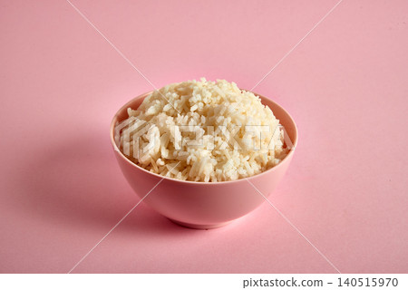 Bowl of tasty white rice boiled on pink Bowl of tasty white rice boiled on pink 140515970
