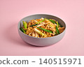 Tasty asian noodles with vegetables on pink background 140515971