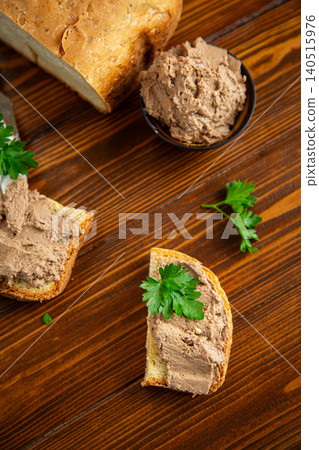Fresh bread with creamy pate on dark wooden table Fresh bread with creamy pate on dark wooden table 140515976