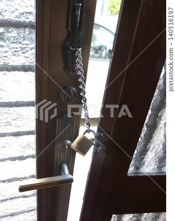 A padlock is attached to the door chain, allowing it to be unlocked from the outside in an emergency. A padlock is attached to the door chain, allowing it to be unlocked from the outside in an emergency. 140516197
