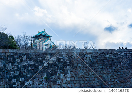 Evening view of the castle tower and stone walls from the plum grove of Osaka Castle Evening view of the castle tower and stone walls from the plum grove of Osaka Castle 140516278