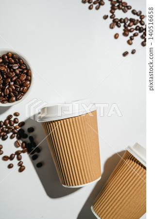 Takeaway coffee cups and roasted coffee beans on white background with copy space, flat lay 140516658