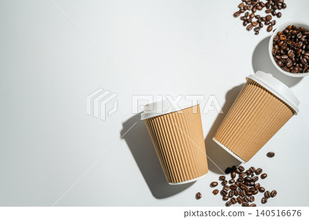 Roasted Coffee Beans and Takeaway Coffee Cups with on Light Background and soft shadows. Copy space Roasted Coffee Beans and Takeaway Coffee Cups with on Light Background and soft shadows. Copy space 140516676