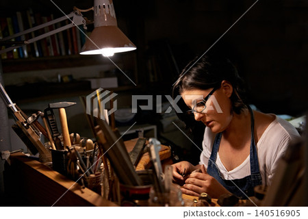 Wood, carving and artist in workshop with creative project or unique sculpture on table at night. Artisan, carpenter and woman with talent for creativity in dark studio in process of woodworking Wood, carving and artist in workshop with creative project or unique sculpture on table at night. Artisan, carpenter and woman with talent for creativity in dark studio in process of woodworking 140516905