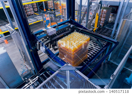 Strapping machine for packaging line. Modern machine for packaging line in factory. Technology and industrial concept. Strapping machine for packaging line. Modern machine for packaging line in factory. Technology and industrial concept. 140517118
