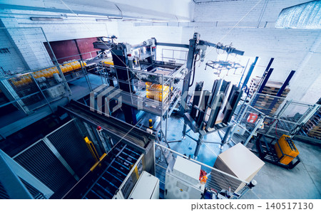Strapping machine for packaging line. Modern machine for packaging line in factory. Technology and industrial concept. Strapping machine for packaging line. Modern machine for packaging line in factory. Technology and industrial concept. 140517130