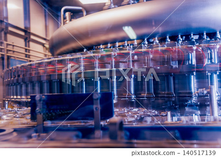 Automatic filling machine pours water into plastic PET bottles. Brewing production. Automatic filling machine pours water into plastic PET bottles. Brewing production. 140517139