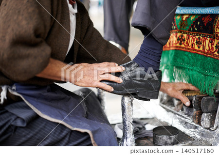Shine, shoes or hands of man in street, city or cleaning service for client or customer with polish or trade. Cloth, brush or feet of businessman in downtown Sao Paulo for footwear or outdoor help 140517160