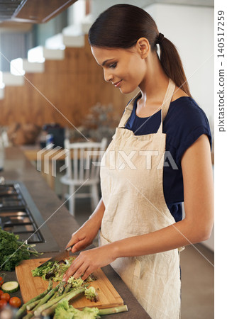 Woman, knife and vegetables in home kitchen with smile, apron and cooking for healthy nutrition for dinner. Girl, person and meal prep with vegan diet for health food, wellness and lunch in apartment Woman, knife and vegetables in home kitchen with smile, apron and cooking for healthy nutrition for dinner. Girl, person and meal prep with vegan diet for health food, wellness and lunch in apartment 140517259