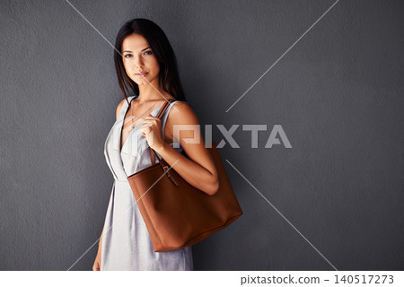 Studio, portrait and handbag with fashion, proud and accessories with cool and dress. Woman, face and model with confidence, beauty and happiness with purse and style isolated on gray wall background Studio, portrait and handbag with fashion, proud and accessories with cool and dress. Woman, face and model with confidence, beauty and happiness with purse and style isolated on gray wall background 140517273