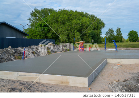 Freshly poured concrete slab with floor heating system outputs for modern residential house project 140517315