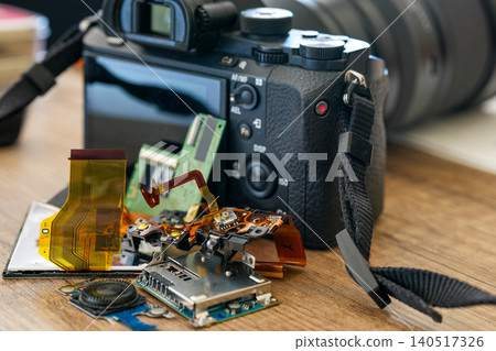 Repaired mirrorless camera with replaced electronic components displayed on workbench after service Repaired mirrorless camera with replaced electronic components displayed on workbench after service 140517326