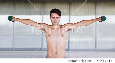 Fitness, studio or man portrait with dumbbell stretch for bicep, challenge or muscle, performance or training. Body, face and male bodybuilder with arm weights for training, exercise and workout Fitness, studio or man portrait with dumbbell stretch for bicep, challenge or muscle, performance or training. Body, face and male bodybuilder with arm weights for training, exercise and workout 140517417
