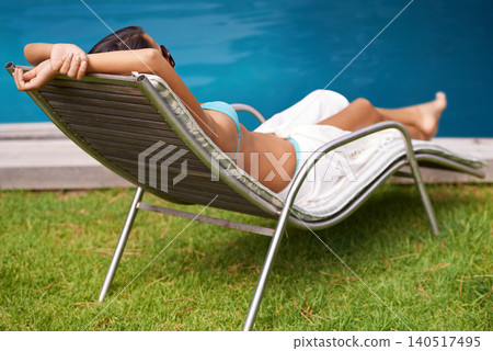 Woman, back or tanning at swimming pool to relax, rest or chill in summer holiday vacation in Hawaii. Calm girl, break and zen person sunbathing on chair in a spa at resort, home or hotel for peace Woman, back or tanning at swimming pool to relax, rest or chill in summer holiday vacation in Hawaii. Calm girl, break and zen person sunbathing on chair in a spa at resort, home or hotel for peace 140517495