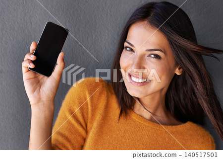 Woman, portrait and phone screen in studio, blank and mockup space for website or app. Female person, breeze and empty display for marketing or advertising, social media and online by gray background Woman, portrait and phone screen in studio, blank and mockup space for website or app. Female person, breeze and empty display for marketing or advertising, social media and online by gray background 140517501