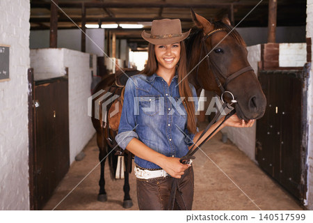 Cowgirl, portrait and happy woman with horse at barn or stable in Texas for recreation. Western hat, person and animal at ranch with pet, livestock or stallion for hobby with care at equestrian farm Cowgirl, portrait and happy woman with horse at barn or stable in Texas for recreation. Western hat, person and animal at ranch with pet, livestock or stallion for hobby with care at equestrian farm 140517599