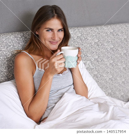 Happy woman, portrait and cup of coffee in bed, relax and warm beverage for wellness in cozy home. Lady, face and positive in bed with cappuccino in morning, healthy and lazy on vacation in apartment Happy woman, portrait and cup of coffee in bed, relax and warm beverage for wellness in cozy home. Lady, face and positive in bed with cappuccino in morning, healthy and lazy on vacation in apartment 140517954
