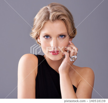 Cosmetic, fashion and portrait of woman in studio with makeup face for elegant, trendy and fancy dress. Beauty, hairstyle and female model with cosmetology routine and classy style by gray background Cosmetic, fashion and portrait of woman in studio with makeup face for elegant, trendy and fancy dress. Beauty, hairstyle and female model with cosmetology routine and classy style by gray background 140518139