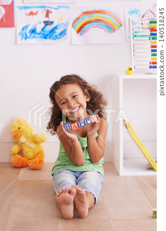Girl, portrait and learning alphabet with blocks in home, child development and growth with letters. Female person, kid and abc on floor for language, bedroom and creative game for education with toy 140518245