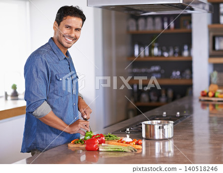 Cooking, portrait and happy man chopping vegetables on kitchen counter for healthy diet, nutrition or lunch. Cutting knife, food and face of person preparing fresh salad for organic meal in home 140518246