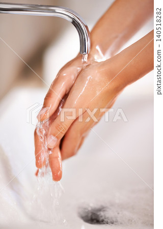 Cleaning, water and soap on hands of person with skincare, routine and grooming in home closeup. Bathroom, tap and washing skin with foam for protection of hygiene from germs, bacteria and virus 140518282