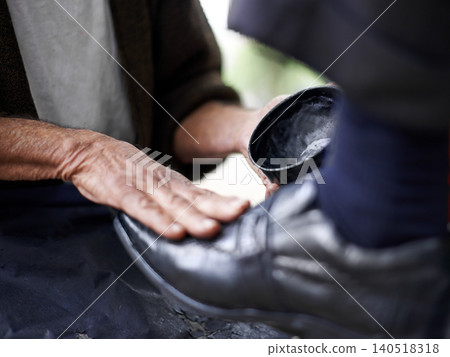 Hands, repairman and polishing with leather shoes for customer in handcraft, startup business and store. Entrepreneur, shoemaker and service with client for footwear, skills and professional. Hands, repairman and polishing with leather shoes for customer in handcraft, startup business and store. Entrepreneur, shoemaker and service with client for footwear, skills and professional. 140518318