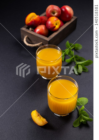 Nectarine juice in glasses on dark background Nectarine juice in glasses on dark background 140518381
