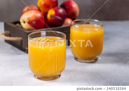 Fresh nectarine juice in glasses with ripe fruit 140518384