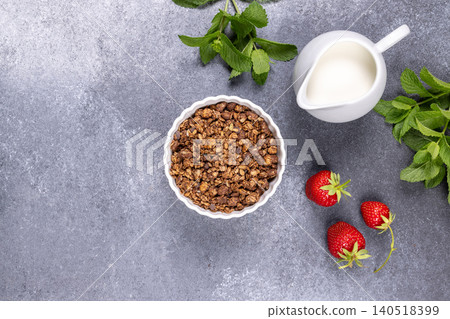Granola bowl with strawberries and milk for breakfast Granola bowl with strawberries and milk for breakfast 140518399